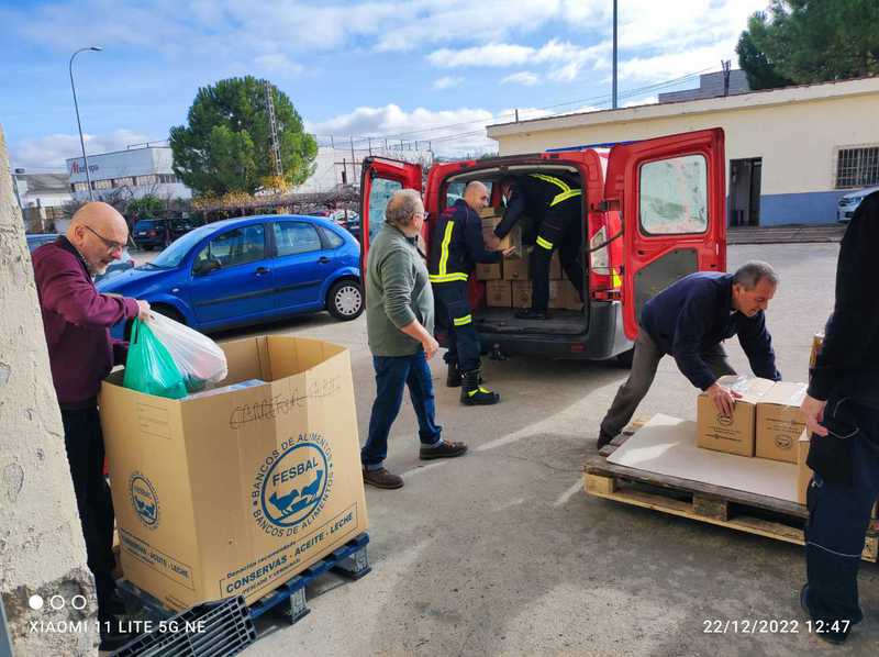 Bomberos y voluntarios descargan alimentos en el Banco de Alimentos