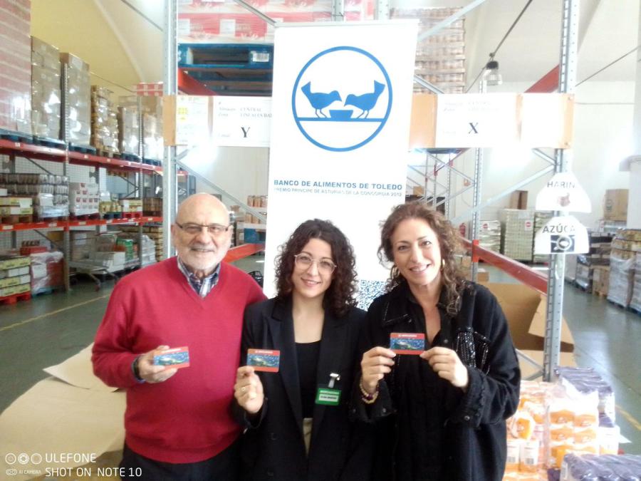 Representantes de Mercadona y del Banco de Alimentos muestran las tarjetas de crédito canjeables en tienda